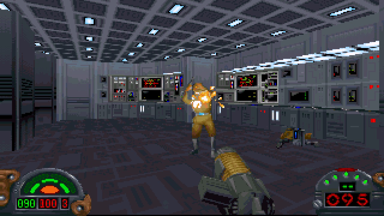 Standbild aus dem Videospiel Star Wars: Dark Forces. Der Raum ist ein futuristischer Computerraum, der im 2.5D-Pixel-Art-Stil gestaltet ist. Du hältst eine Waffe und schießt auf einen Gegner vor dir.